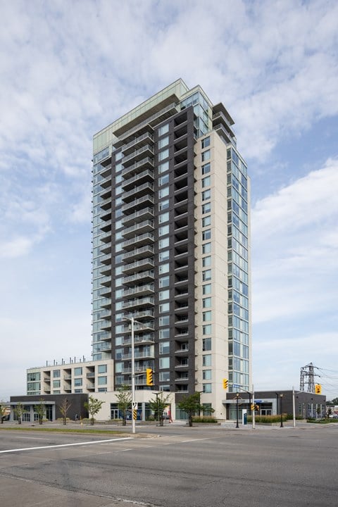 A tall building with many windows is in the background.