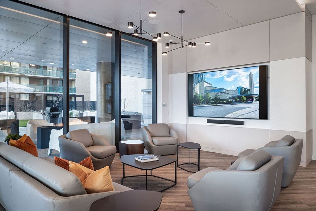 a living room with couches and chairs and a television