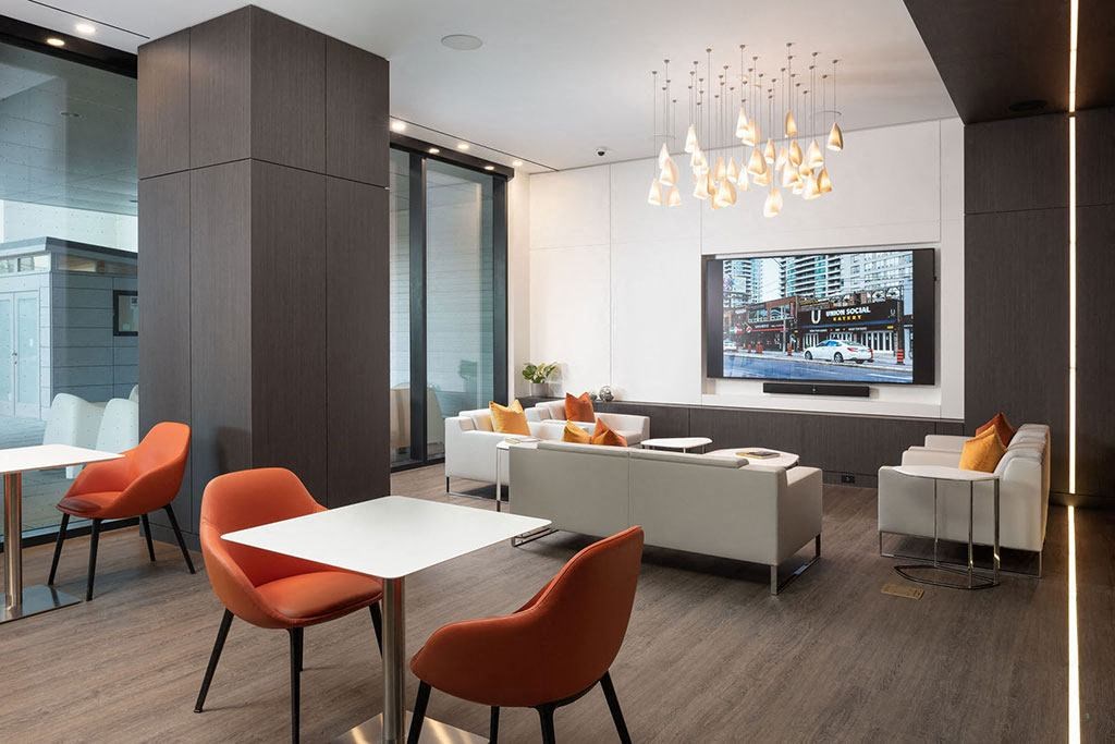 a living room with a tv and a table and chairs