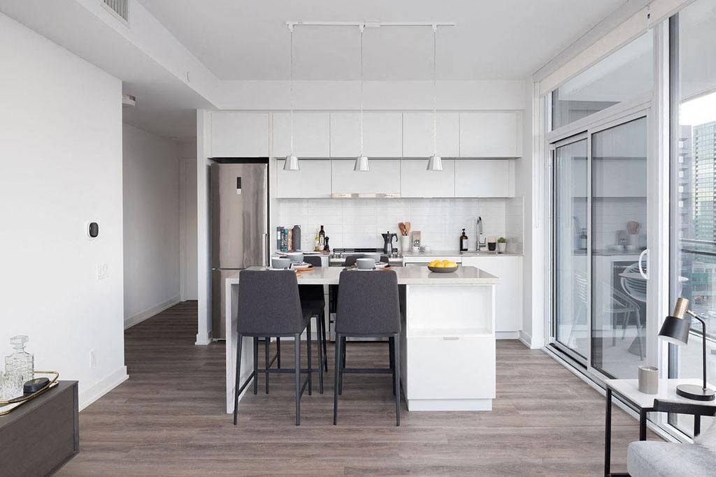 A modern kitchen with a dining table and chairs.