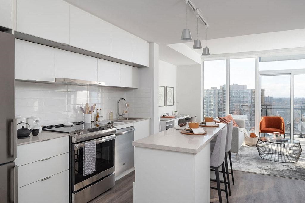 A modern kitchen with a dining table set for four.