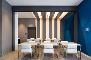 A conference room with a long table and chairs.