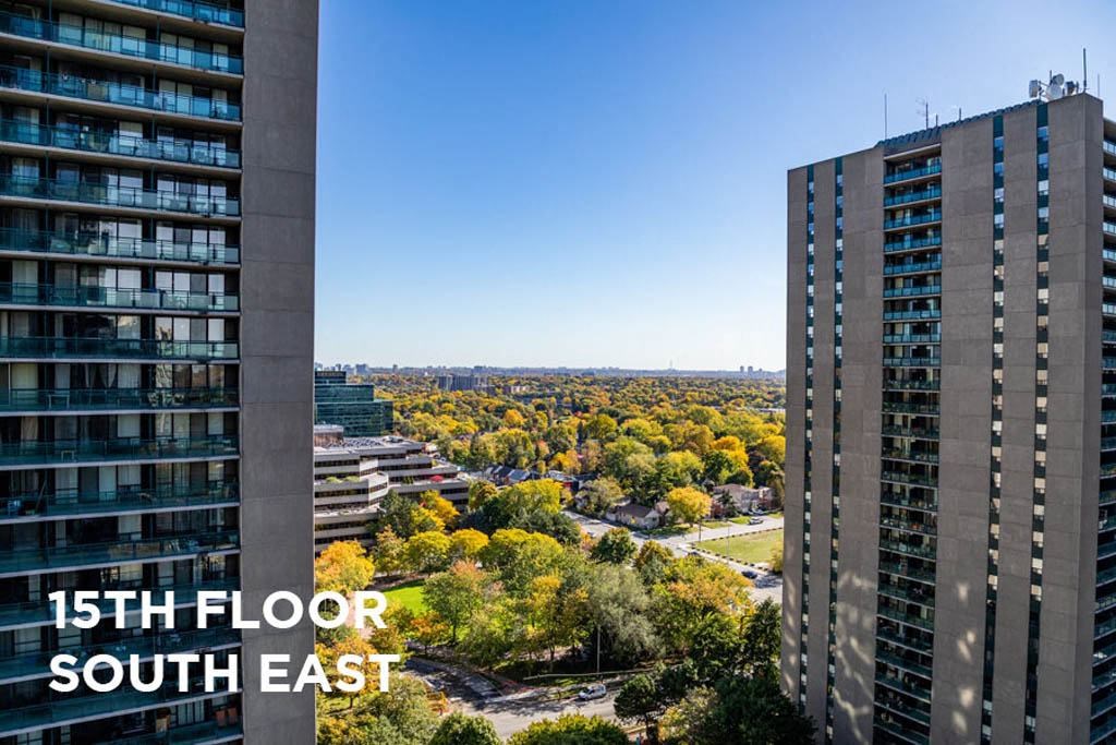 a view of the city from a skyscraper overlooking a park between two tall buildings