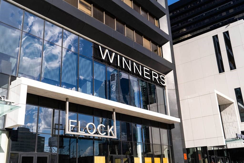 the facade of a building with a wineries clock sign on it