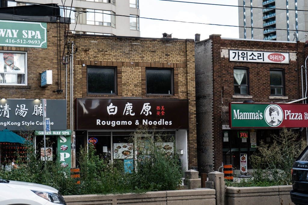 a brick building with some signs in front of it