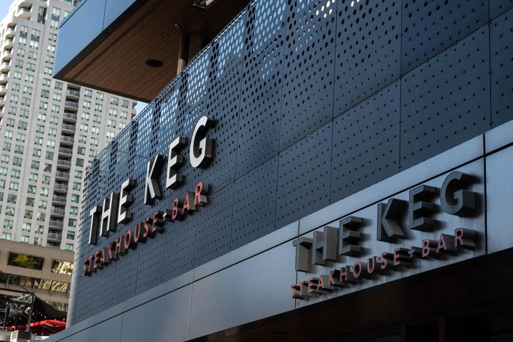 a sign on the side of a building with skyscrapers