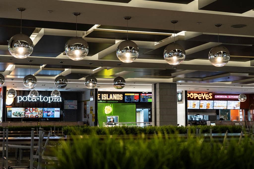 a restaurant in a mall with tables and chairs