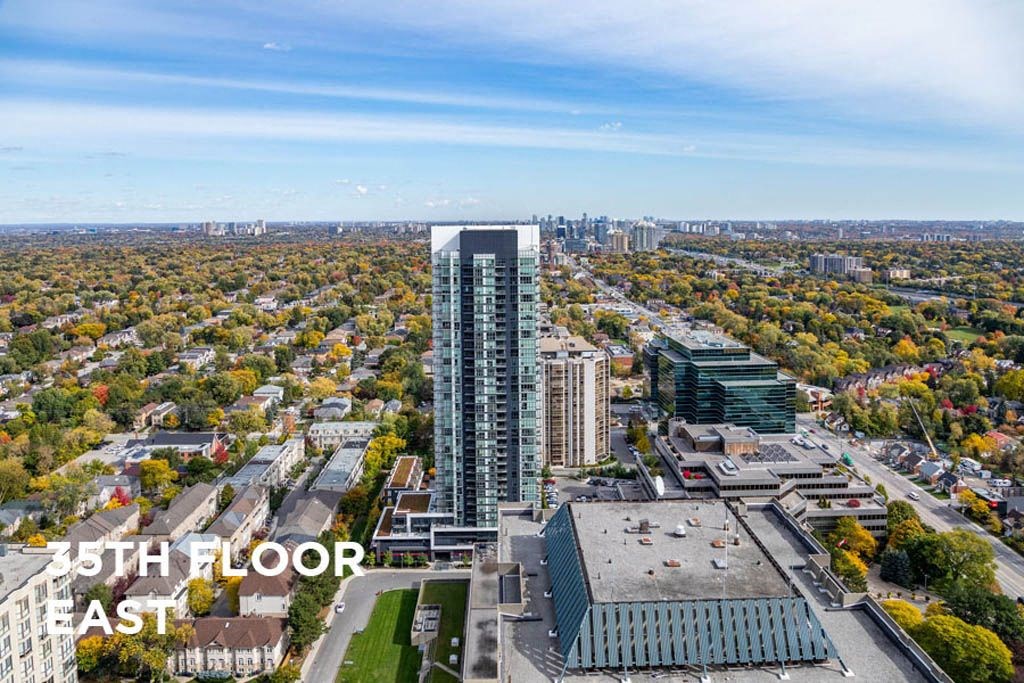 an aerial view of a city with a tall skyscraper