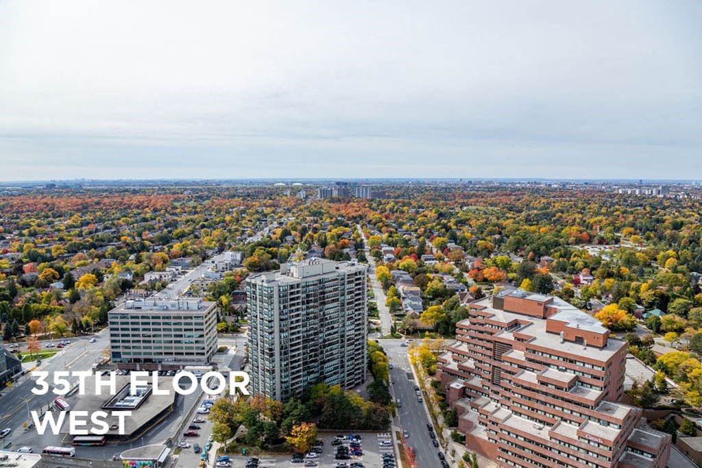 an aerial view of a city with tall buildings and trees