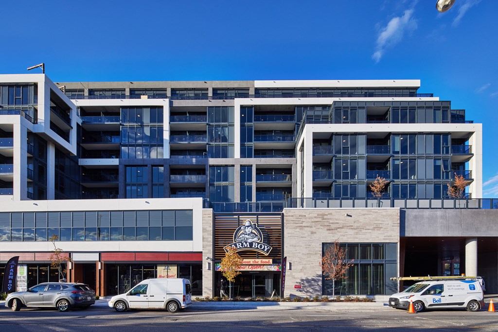 a large apartment building with cars parked in front of it