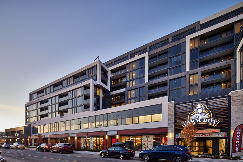 a large building with cars parked in front of it on a city street