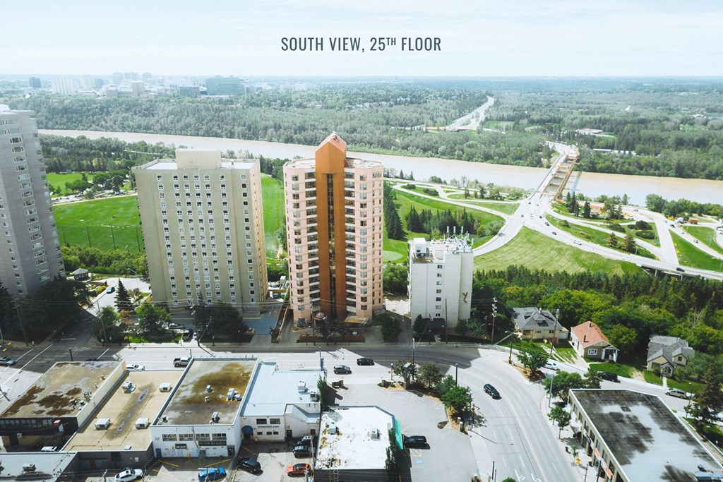 an aerial view of a city with tall buildings and a river