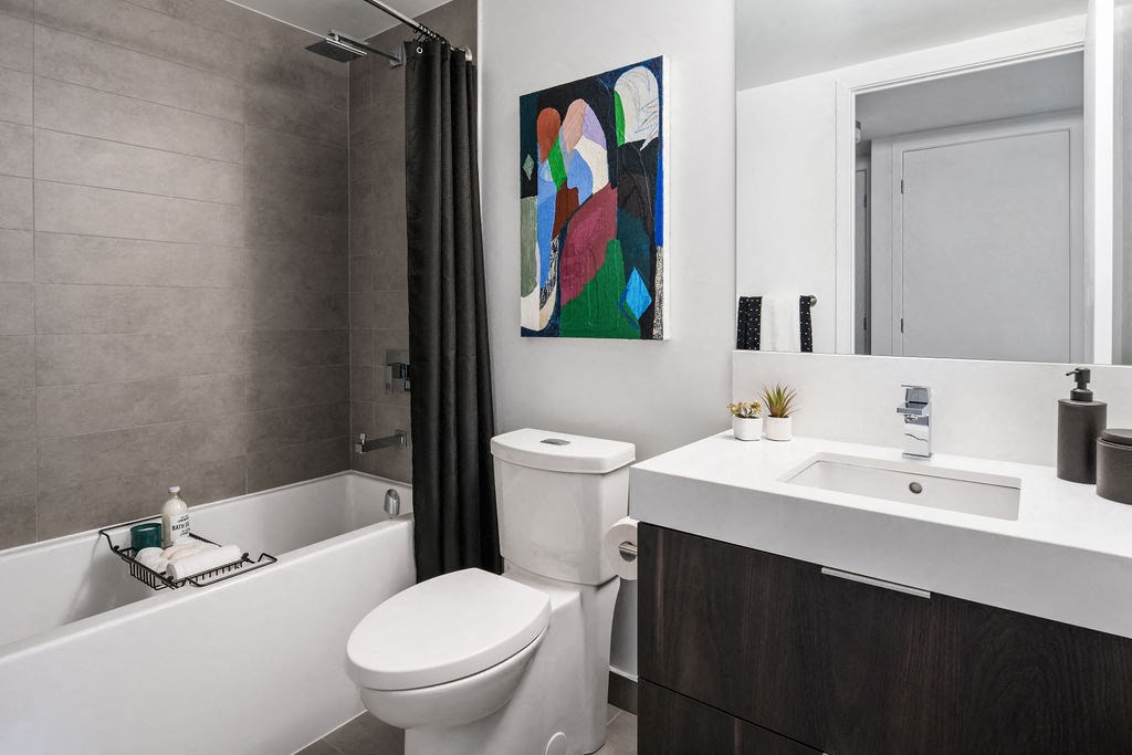 a bathroom with a toilet sink and a bath tub