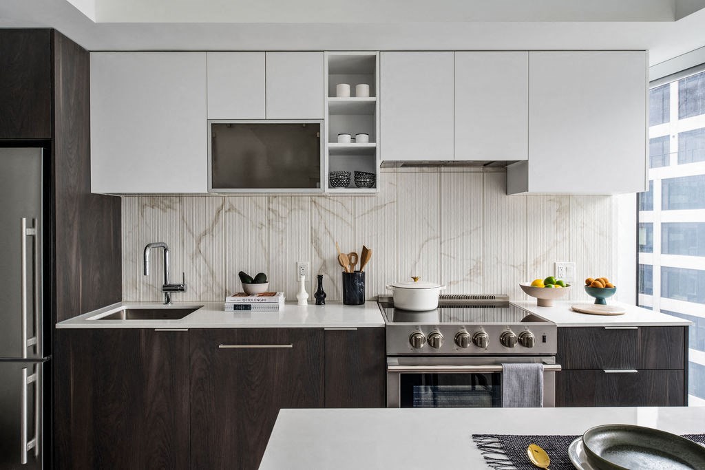 a kitchen with white cabinets and a sink and a stove