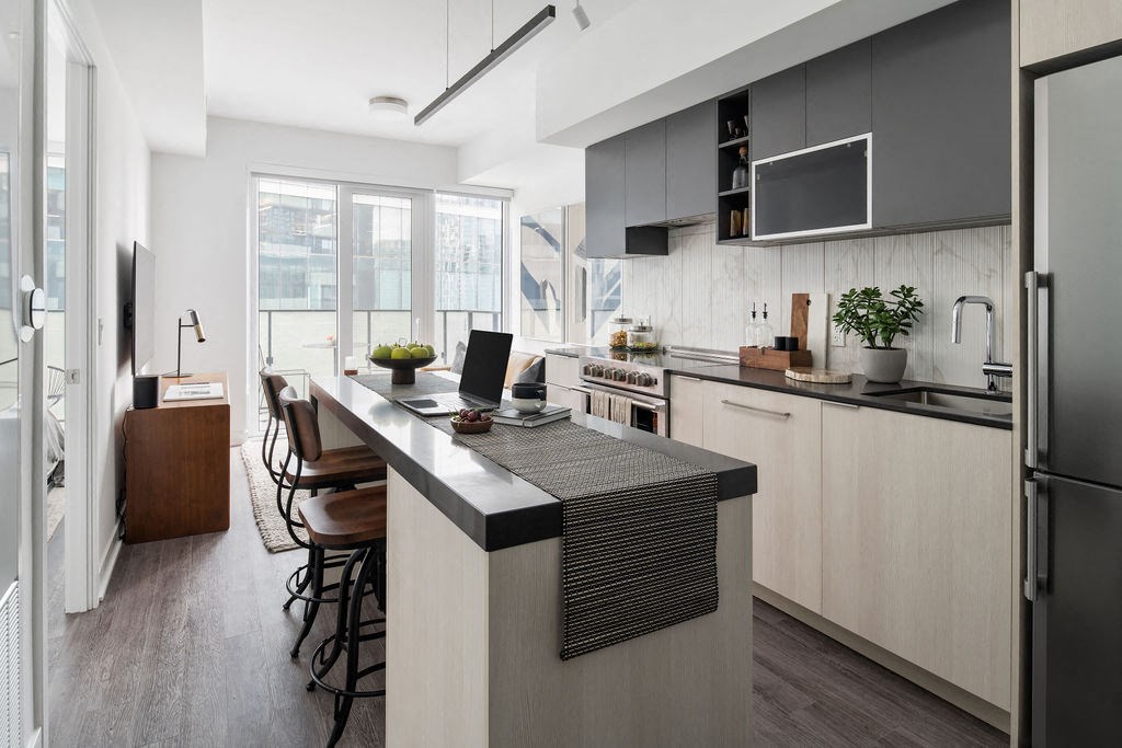 a kitchen with a large island and a table with chairs