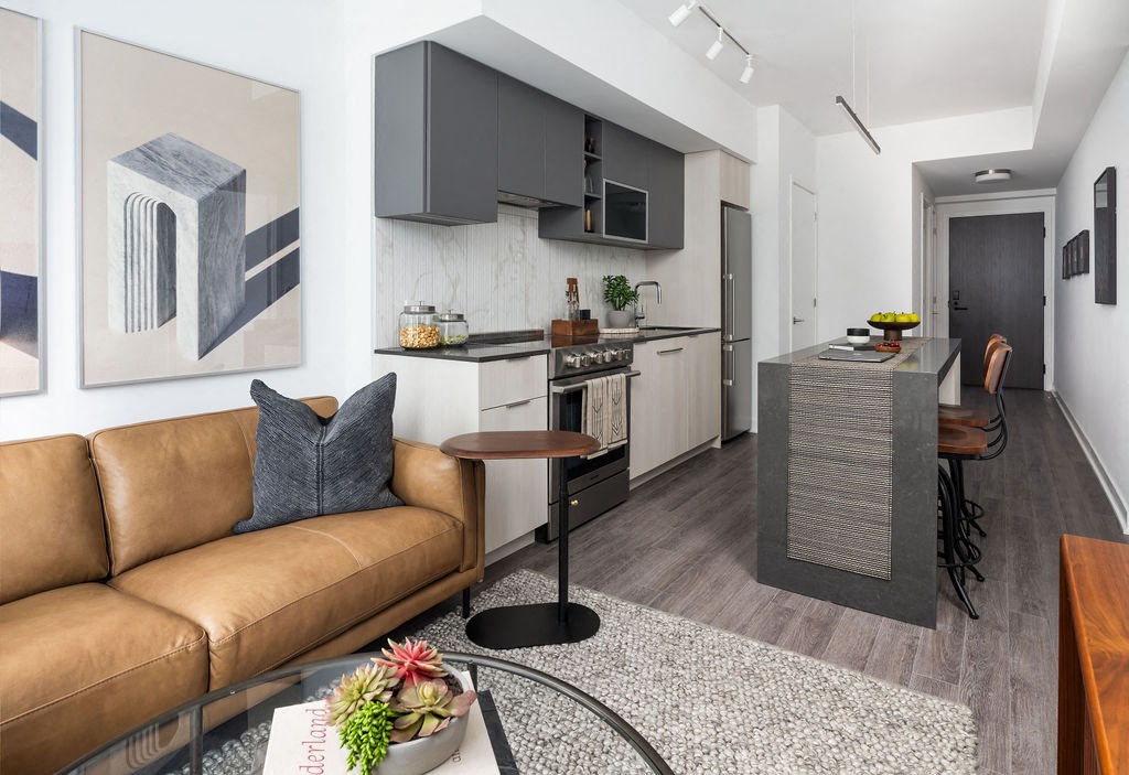 a living room with a couch and a kitchen