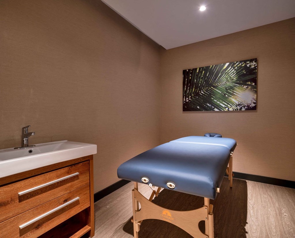 a massage table in a room with a sink