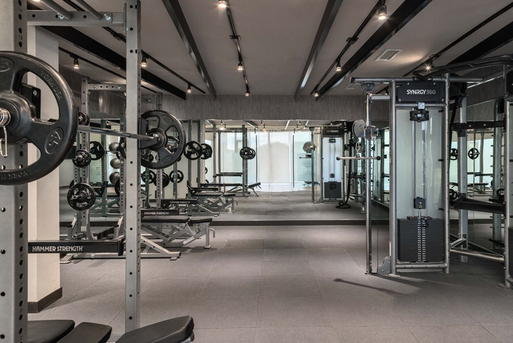 a gym with weights and other equipment in it