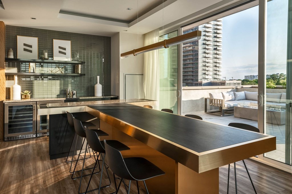 a kitchen with a long counter top and a table with chairs