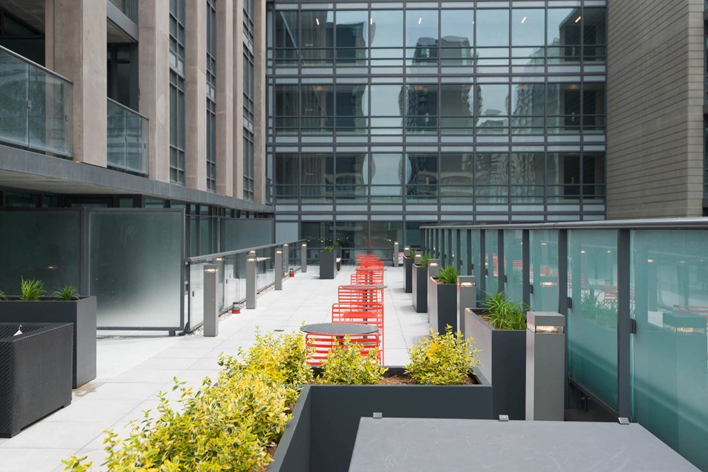a row of red chairs in front of an office building