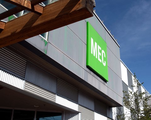 A building with a green sign that says MEC.