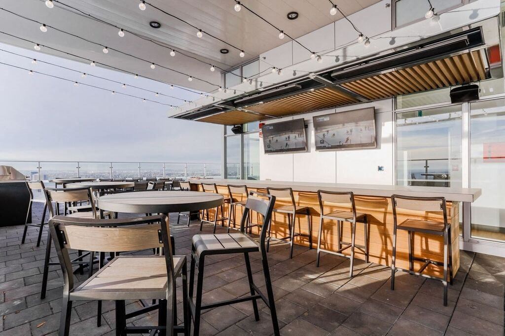 a dining room with tables and chairs and a bar