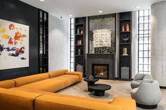 a living room with black and yellow furniture and a fireplace