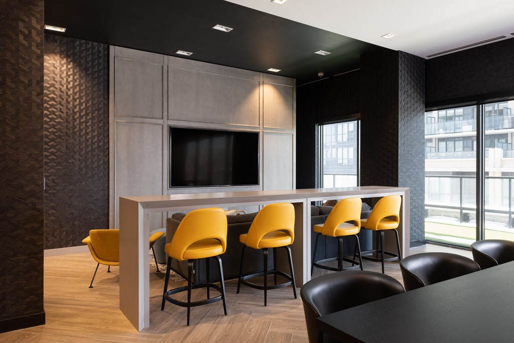 a meeting room with a table and chairs and a television