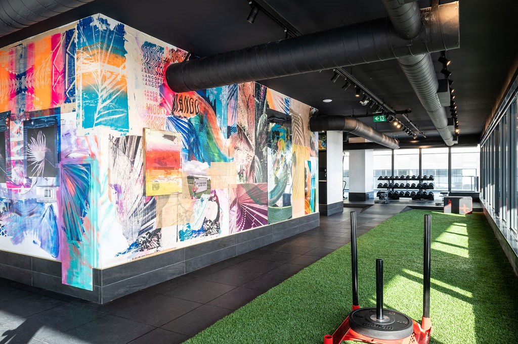 a colorful wall in a lobby with grass