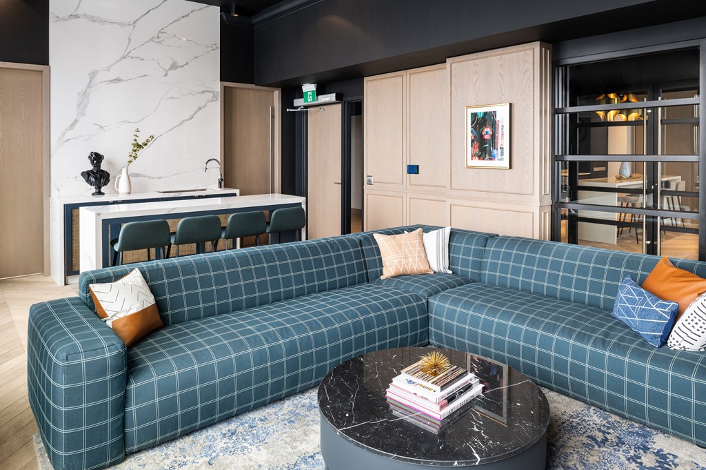 a living room with a blue couch and a coffee table