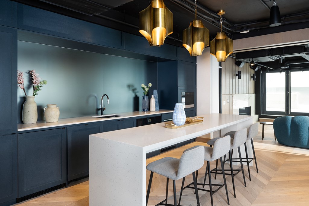 a kitchen with blue walls and a long white counter top