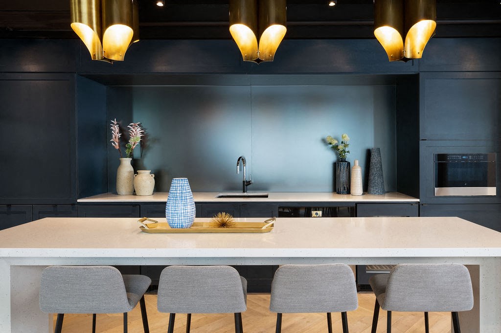 a kitchen with blue walls and a white table and chairs
