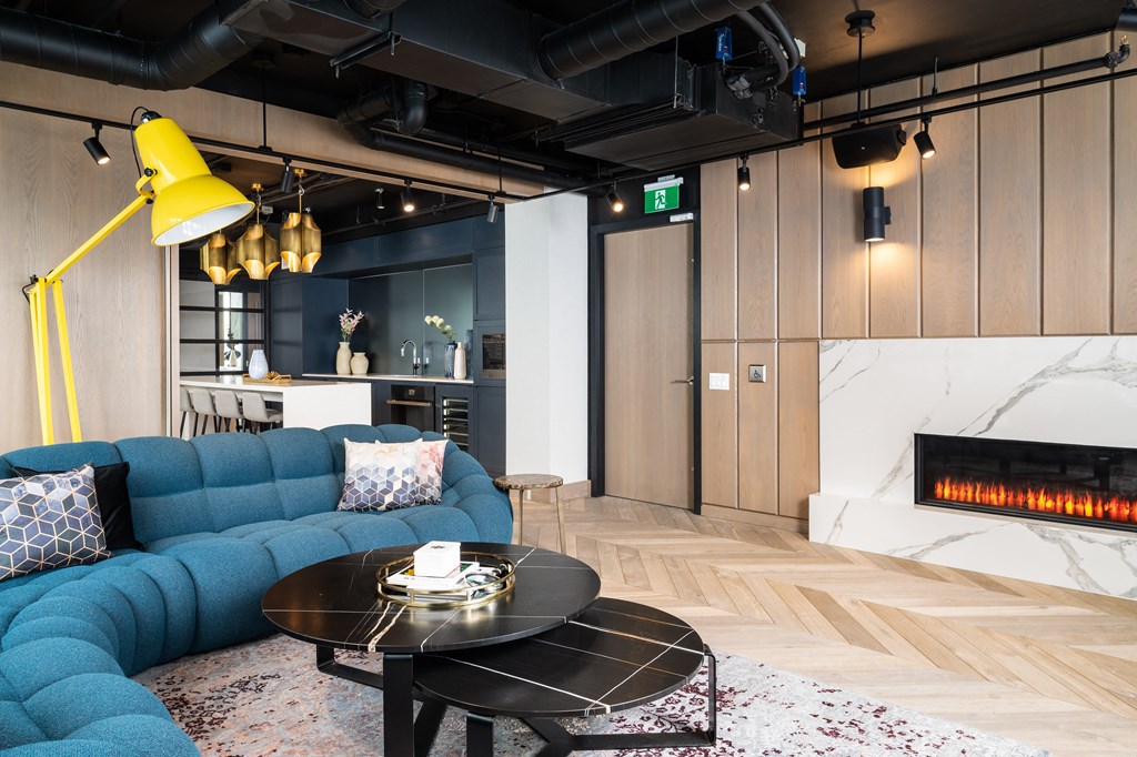 a living room with a blue couch and a coffee table