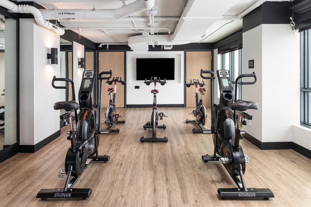 a spin class room with exercise bikes and a tv in the corner