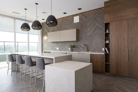 a large kitchen with a large white island and chairs