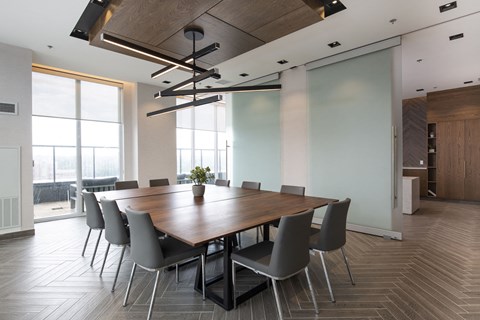 a conference room with a long wooden table and chairs