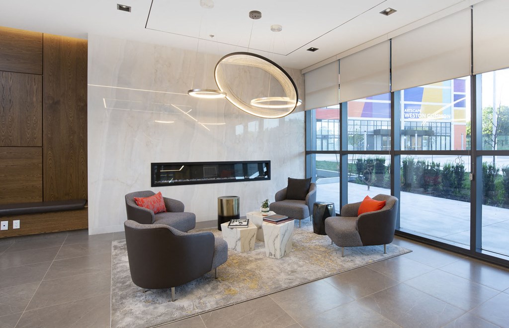 a living room with chairs and a table