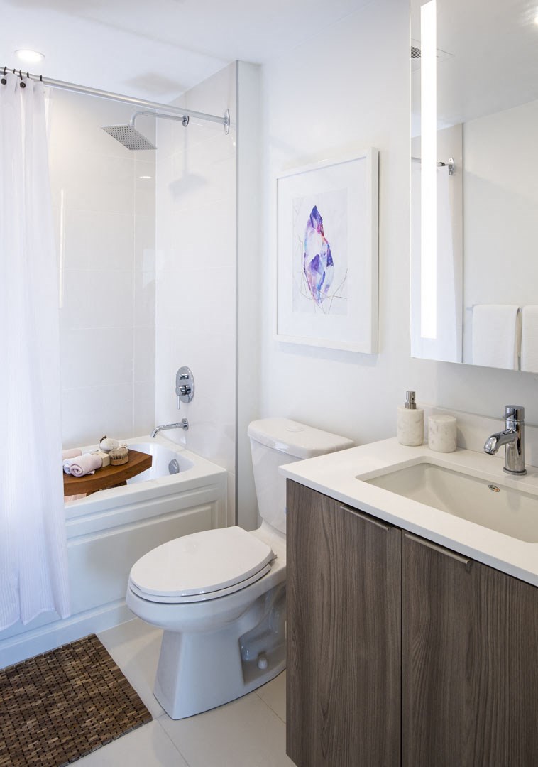 a white bathroom with a toilet sink and shower