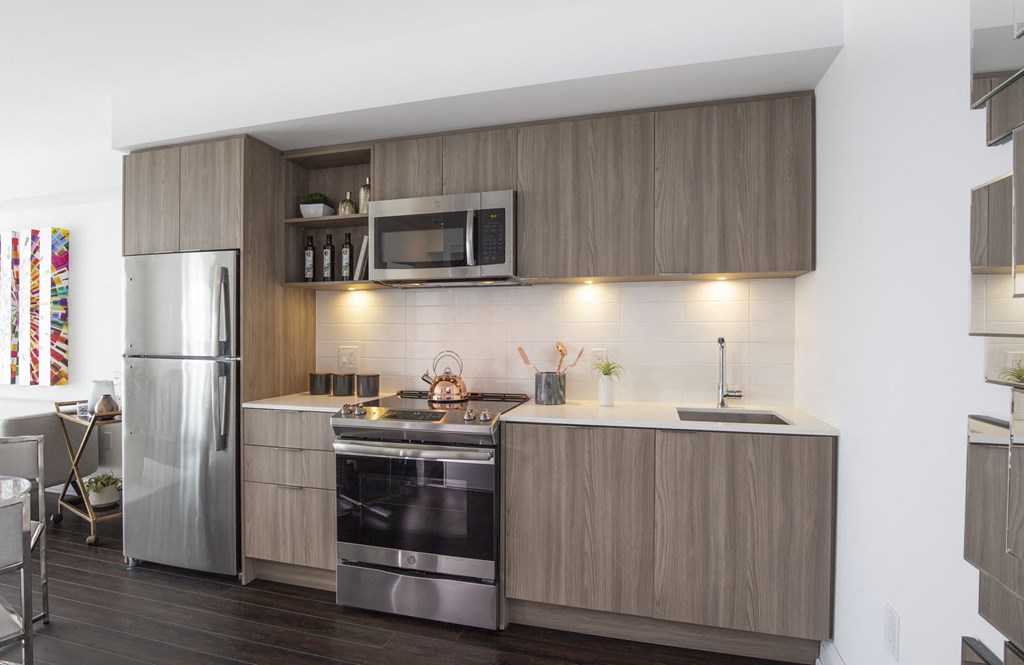 a kitchen with wooden cabinets and stainless steel appliances