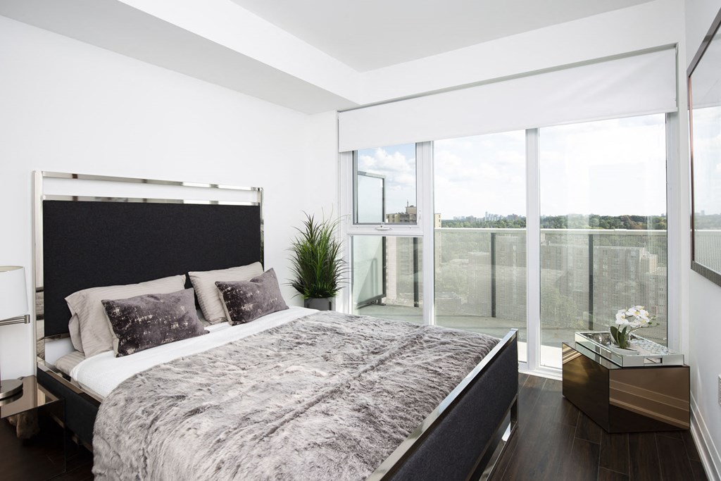 a bedroom with a bed and a large window