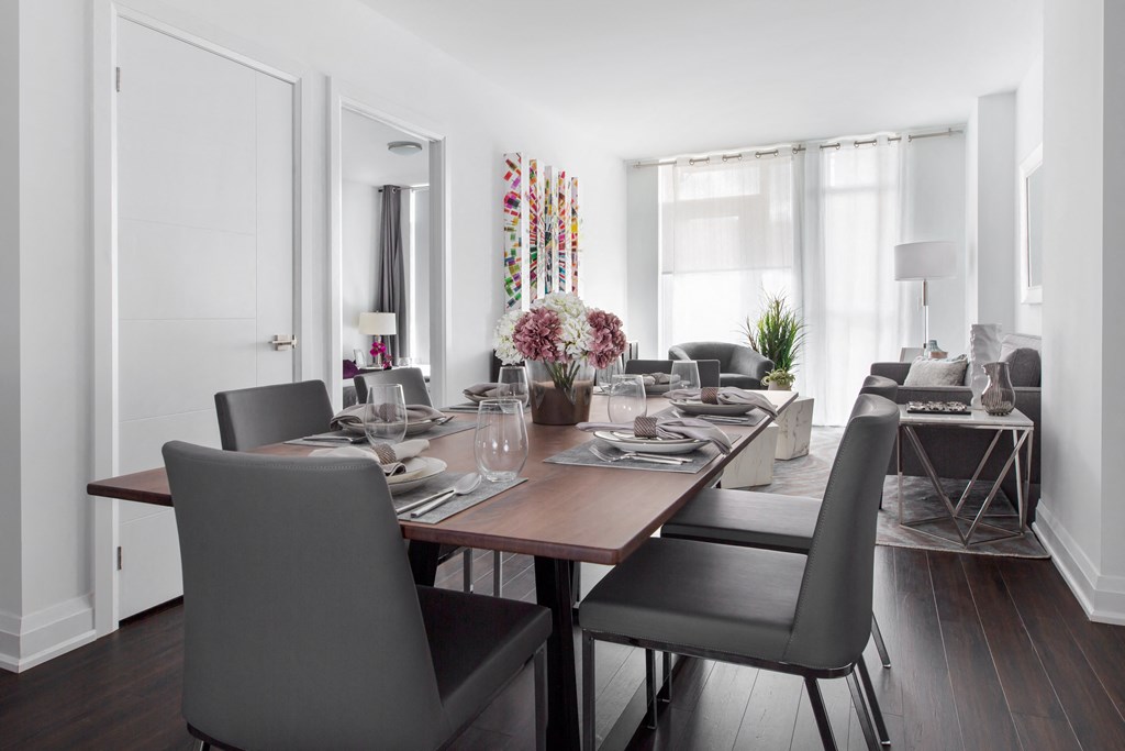 a dining room with a long wooden table and black chairs