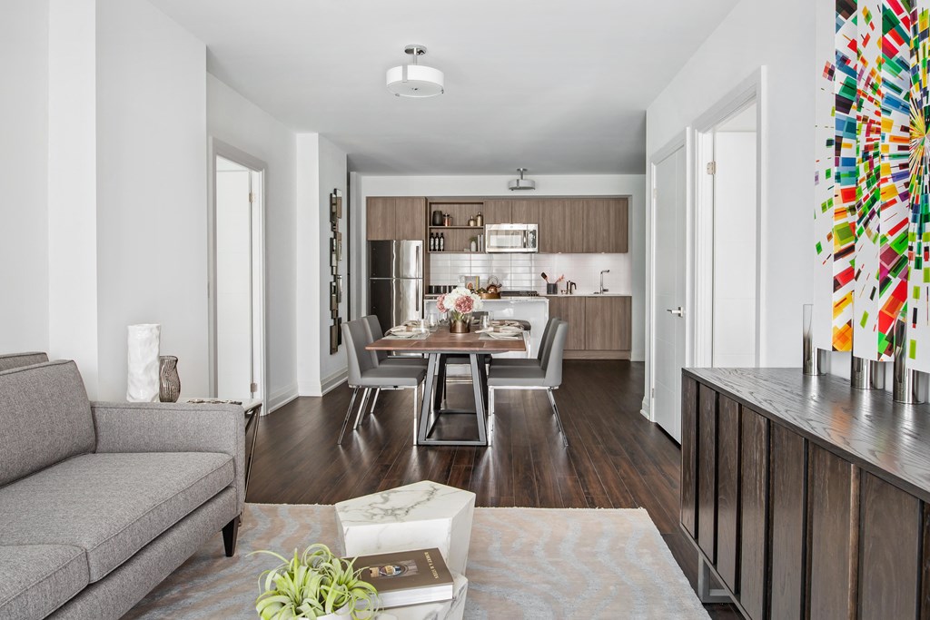 a living room and kitchen with a table and chairs