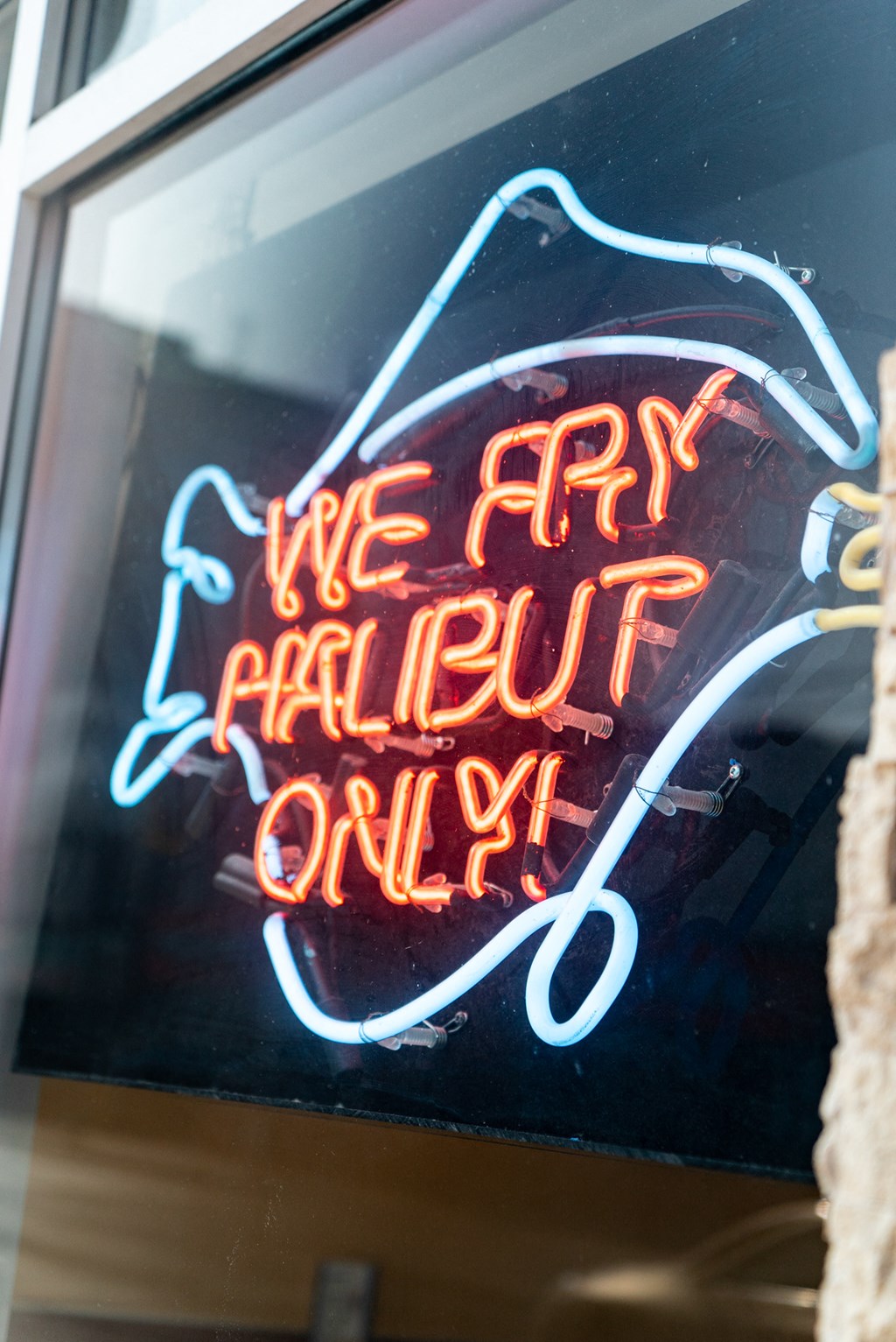 a neon sign in a window that reads we are halliburton only