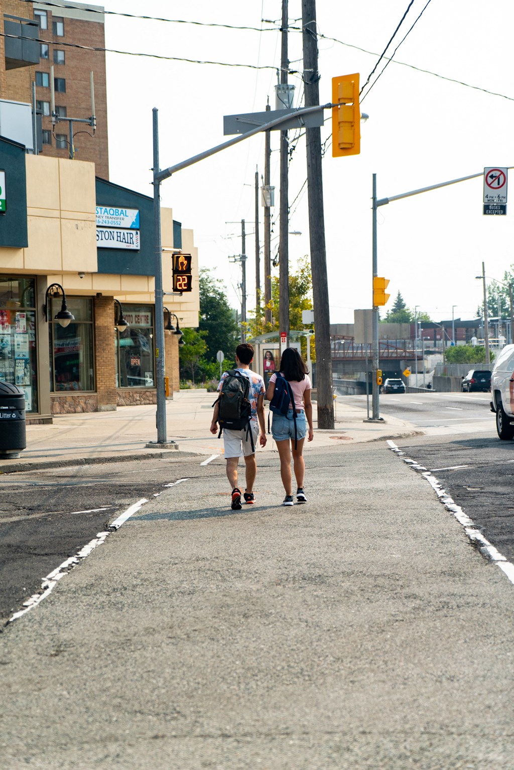 people crossing the street at a crosswalk on a city street