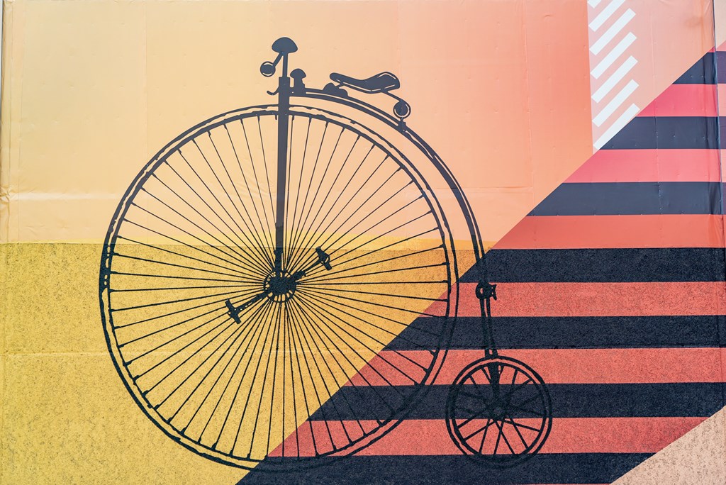 a silhouette of an old bike with its shadow on the ground
