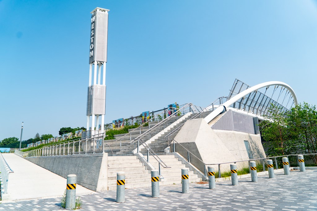 a large staircase leading up to a large monument with a bridge over a river