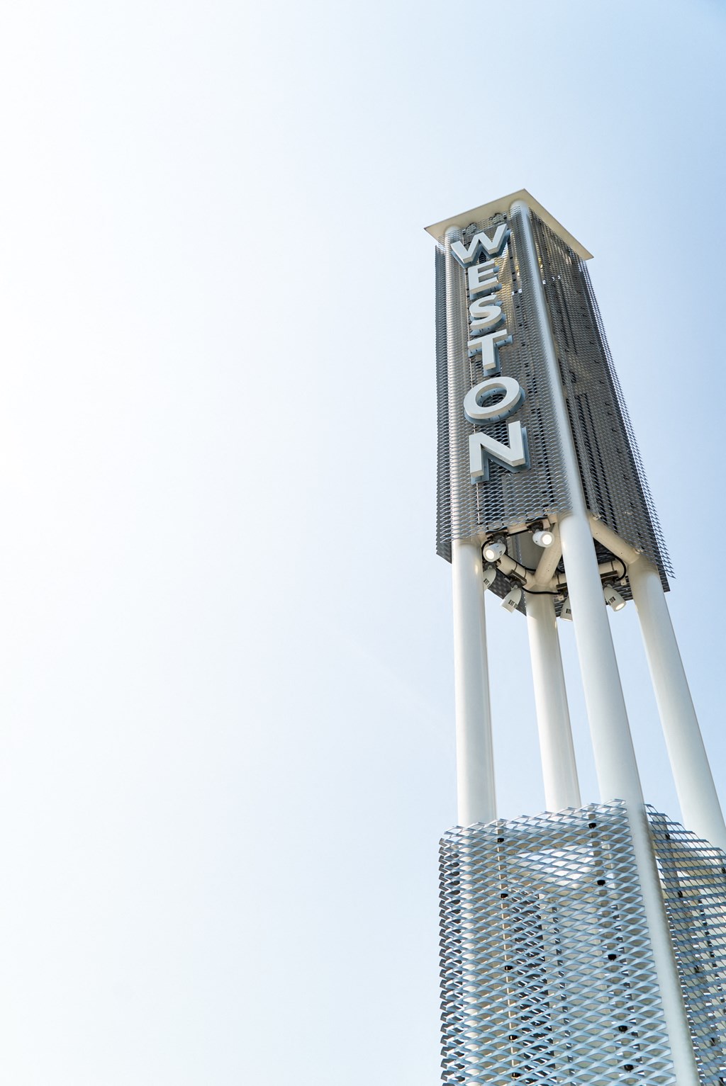 a tall tower with a sign on top of a skyscraper