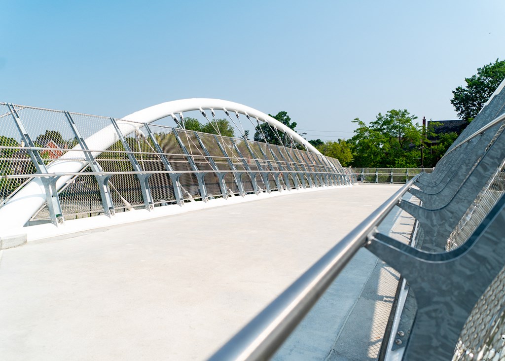 a white bridge with a railing and a white slide on it