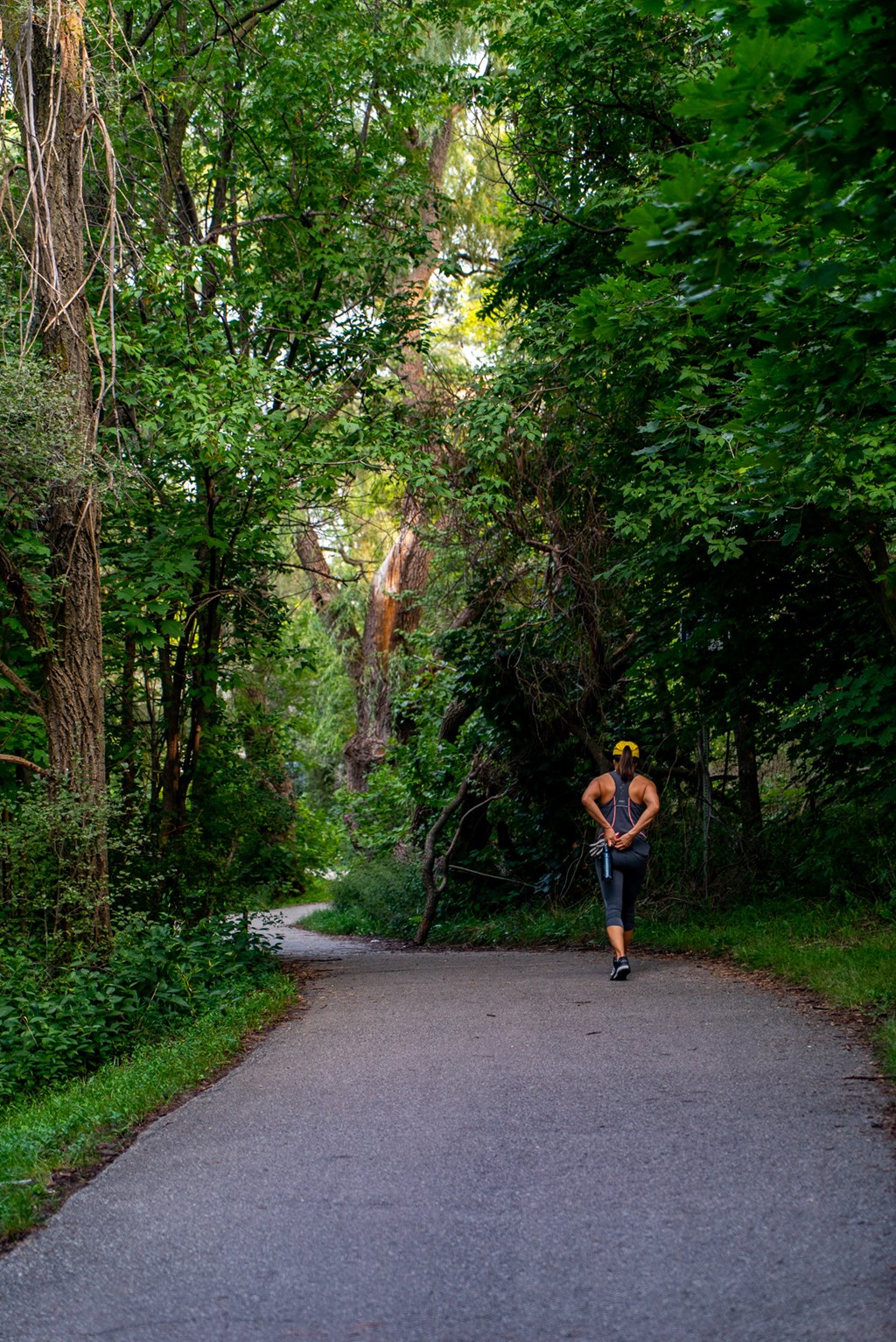 a man running down a path through a forest