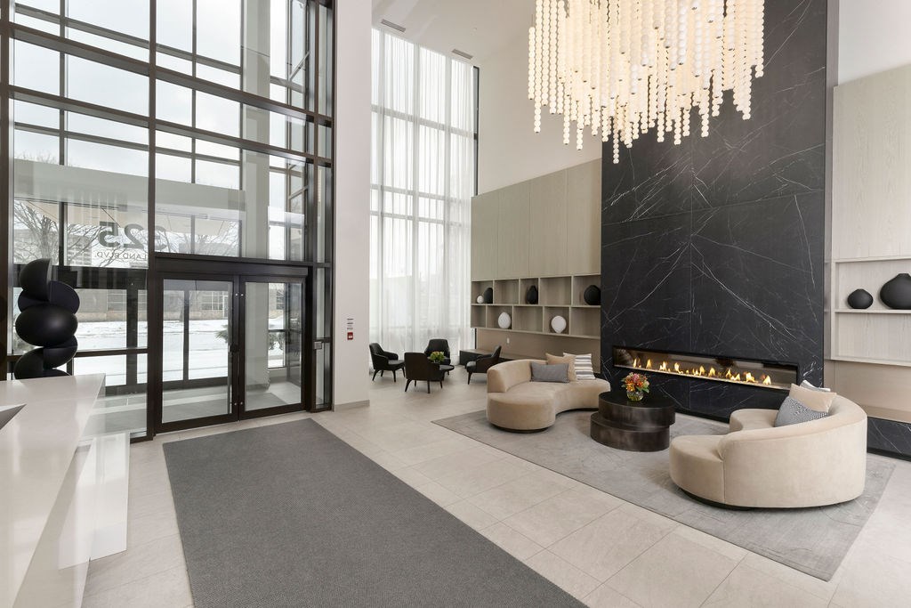 A modern living room with a fireplace and a chandelier.